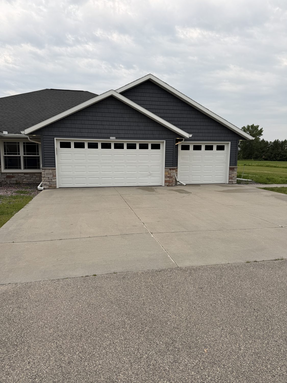 Home exterior with a freshly cleaned concrete driveway